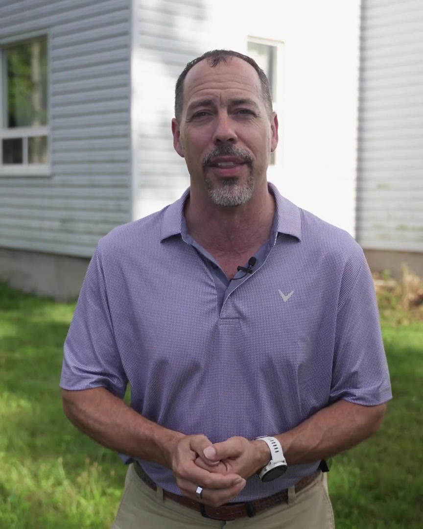 Kory MacKinnon of Strategic Success Consulting speaking outside a house